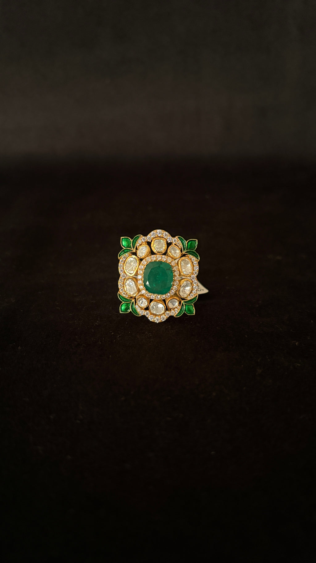 Sia Polki Panna Meena Ring – cushion cocktail ring with oval emerald centre, moissanite polki halo and green meenakari enamel leaf corners, adjustable band, handcrafted in Jodhpur