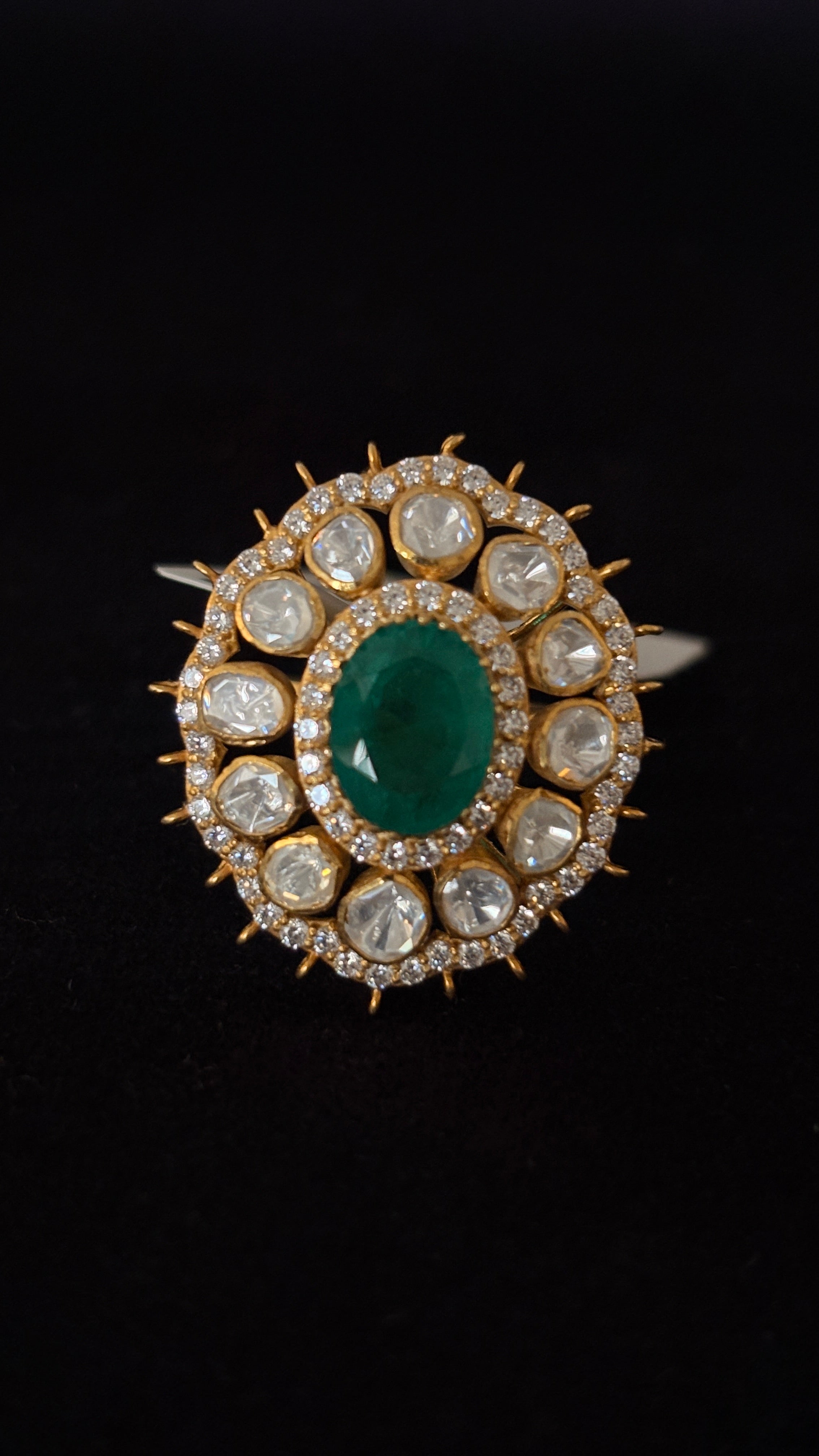 Sia Polki Panna Suraj Ring – oval emerald centre cocktail ring with ten moissanite polki and spiked gold sunburst AD border, adjustable band, handcrafted in Jodhpur