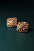 Sia Polki Choras Studs – cushion-shaped moissanite polki stud earrings fully paved in polki with AD stone border, handcrafted in Jodhpur, photographed on teal background