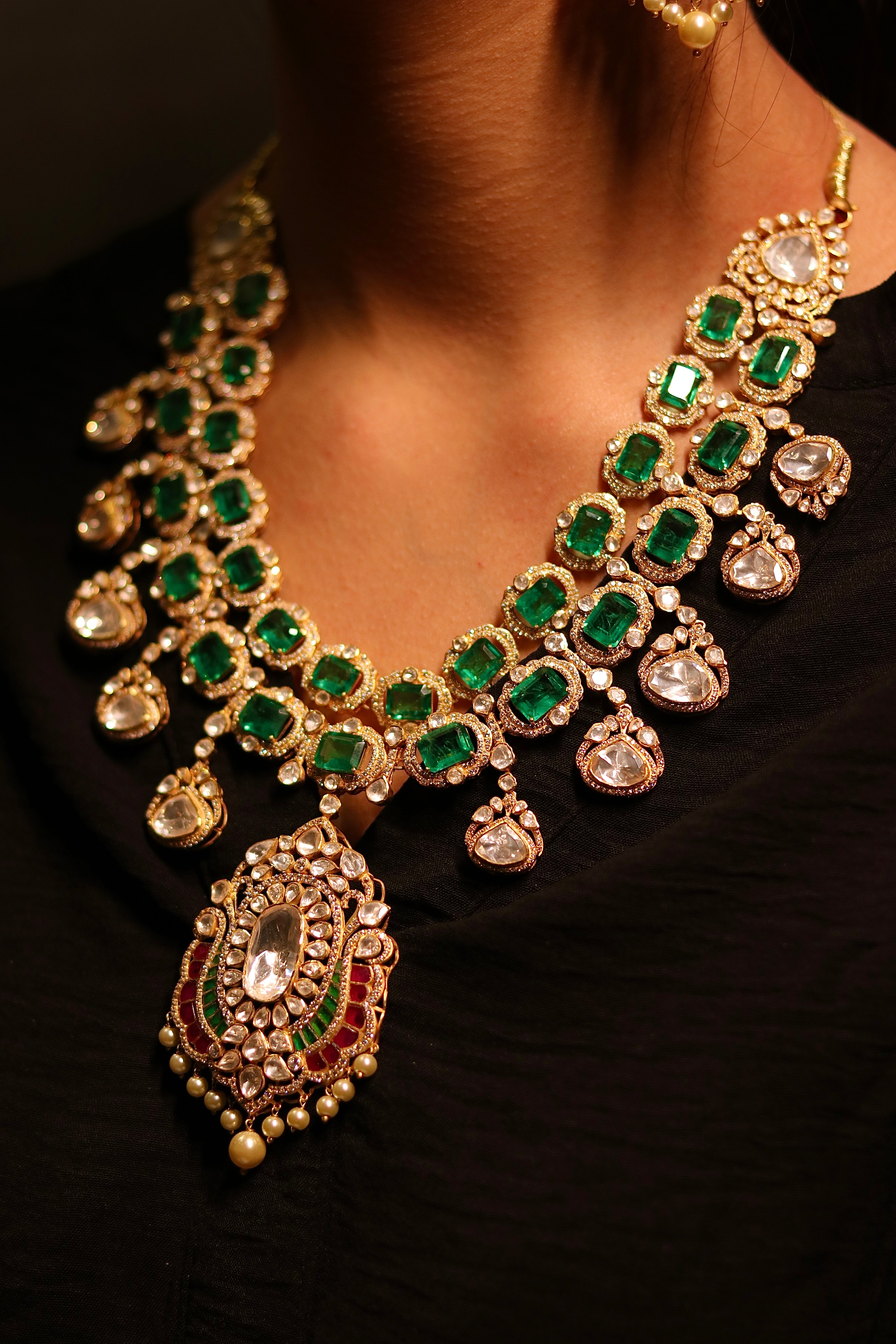 Zehra emerald polki haar set flat lay — gold plated silver bridal necklace with Colombian emerald and polki stones by Sia Polki Jaipur