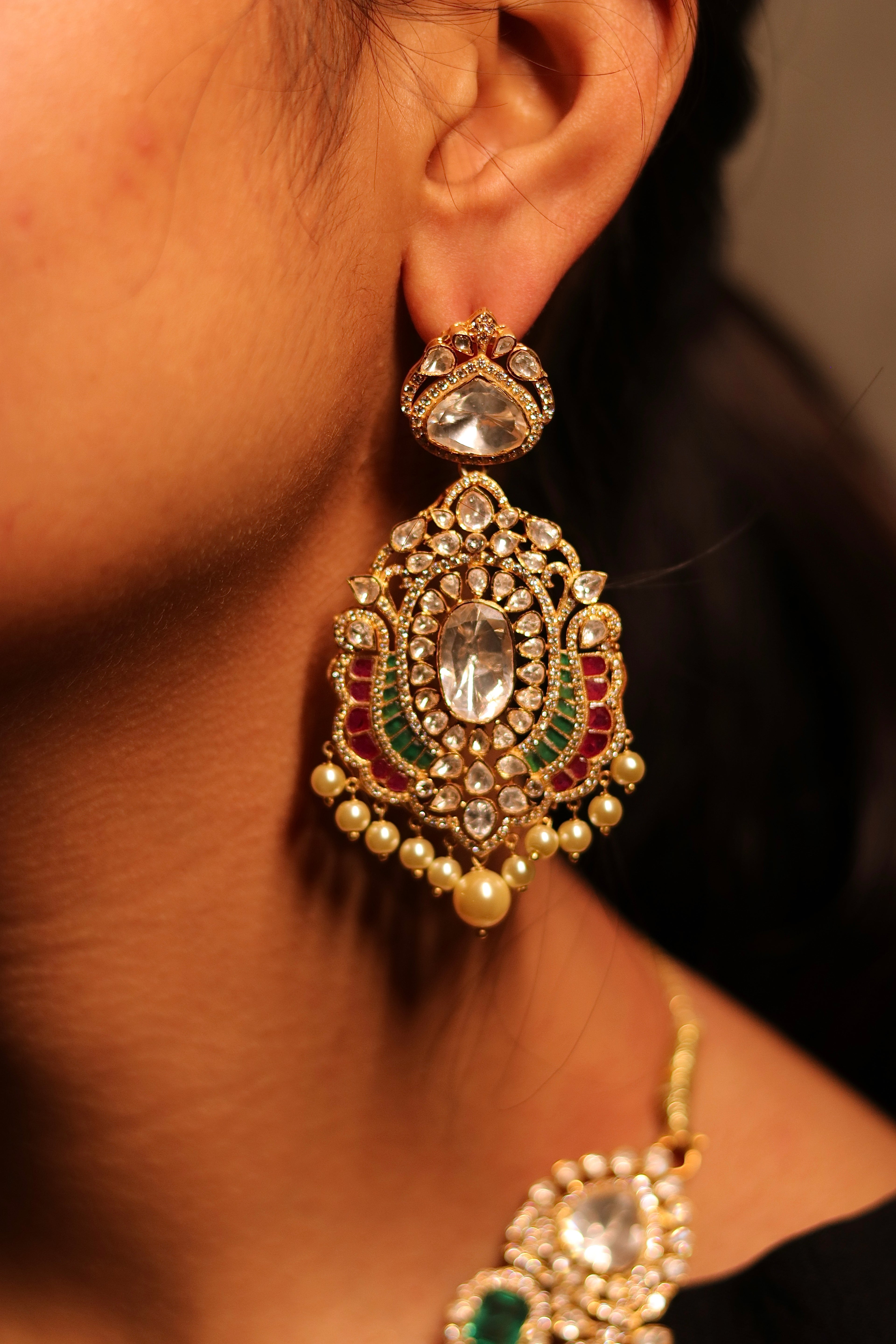 Zehra polki chandbali earrings close-up — 925 silver gold plated with emerald and polki stones by Sia Polki